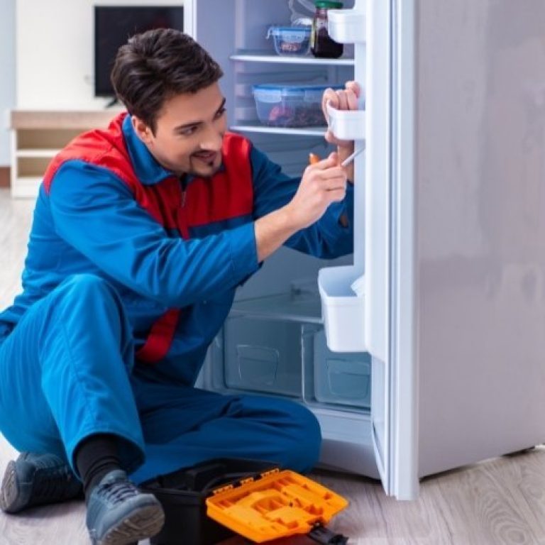 Man repairing fridge - Jyoti electronics